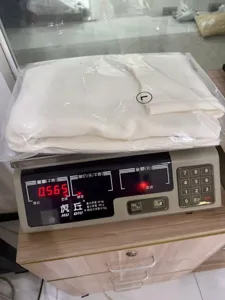 Detailed view of the white turtleneck knit sweater, folded neatly in package showing L size.