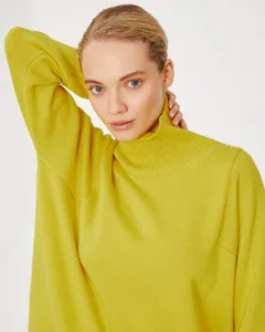Close-up detail of women's stylish yellow turtleneck knit sweater, soft and warm fit.
