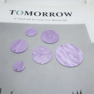 Nahaufnahme von lila marmorierten Acryl-Rundelementen, ideal für DIY-Schmuckhandwerk.