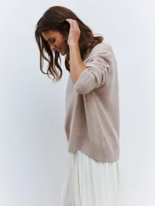 Detail view of casual women's knit sweater featuring loose fit and elegant high collar design.