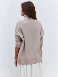 Detailed view of the back of a cozy women's turtleneck knit sweater with ribbed cuffs.