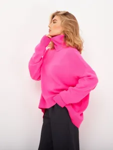 Detail view of women's bright pink turtleneck sweater, featuring cozy ribbed knit texture.