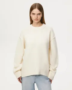 Detailed close-up view of women casual loose crewneck knit sweater in solid beige color.