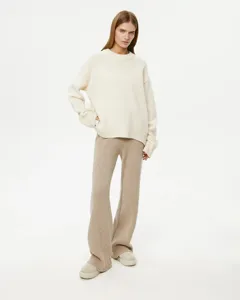 Detailed view of the soft knit sweater texture and ribbed pants design in cozy style.