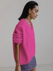 Oversized V-neck long sleeve knit sweater detail showing relaxed fit and soft texture.