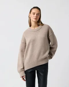 Detailed view of the casual beige crewneck knit sweater, showing soft texture and cozy fit.