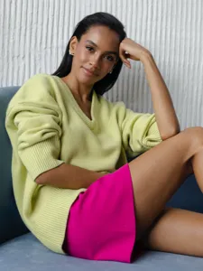 Detailed view of women's V-neck loose long sleeve knit sweater worn by model, cozy daily style.