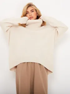 Oversized beige turtleneck sweater for women, perfect for autumn and winter daily fashion wear.