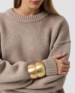 Cozy casual crewneck knit sweater in solid beige, paired with stylish wide metal bangles.