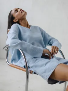 Light blue V-neck knit sweater detail view, casual loose long sleeve top for women fashion wear.