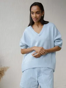 Close-up detail of women's autumn winter loose long sleeve v-neck knit sweater in light blue