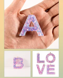 Close up view of resin letter pendant with colorful sequins, perfect for DIY keychains and jewelry.