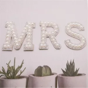 Close up of pearl rhinestone letter patch MRS, perfect for DIY clothing and hat decoration.