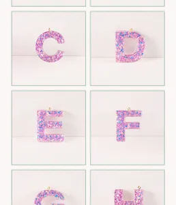 Close-up details of glitter resin alphabet letter charms, sparkling keychain pendant supplies.