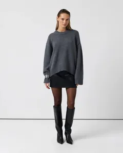 Detail view of women's cozy crewneck knit sweater, showcasing loose fit and soft texture.