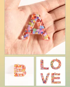 Resin alphabet letter charms with colorful heart sequins, DIY keychain and bag pendant accessories.
