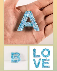 Blue resin letter pendant DIY jewelry making charms with glitter and shell flakes for crafts.