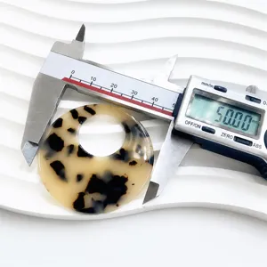 Tortoiseshell acetate round jewelry component detail view, ideal for DIY handmade earrings.