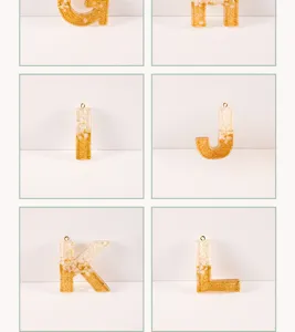 Detail view of resin letter charms with gold glitter for custom keychains and DIY crafts.