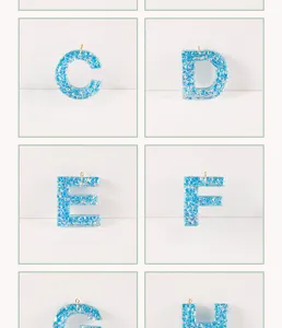 Resin letter pendant detail view, blue glitter shell epoxy charm for DIY jewelry making.