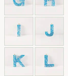 Resin alphabet letter charms with shimmering glitter flakes, perfect for DIY jewelry crafting.