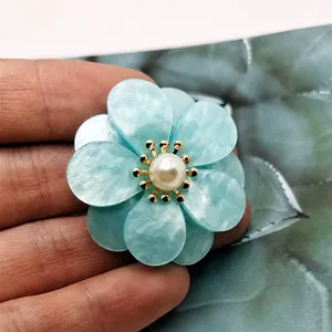Close-up of 3D double five-petal flower DIY jewelry accessory with faux pearl center.