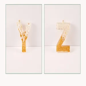 Epoxy resin letter Y and Z charms detail shot showing gold glitter and white stone accents.