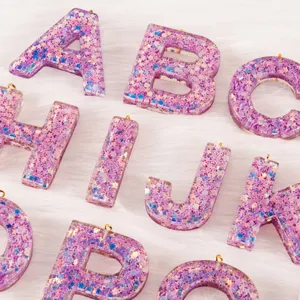 Glitter resin alphabet letter charms detail, perfect for DIY keychains and bag pendants.