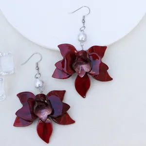 Detailansicht dunkelroter Acryl Blumen Ohrringe mit Perlenakzent und glänzendem Metallhaken.