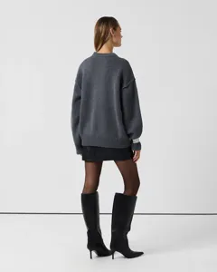 Detailed back view of a cozy oversized grey knit sweater, comfortable relaxed fit style.