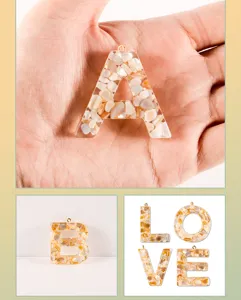 Resin crushed shell letter pendant detail, DIY handmade keychain accessory close-up view
