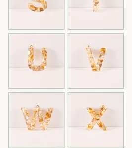 Resin shell letter pendant close-up, showing natural crushed texture and glossy finish.