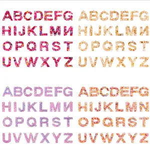 Resin letter charms DIY jewelry pendants with glitter and shell flakes for crafting.