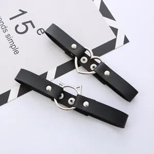 Black faux leather leg garter with metal heart and cat ear rings, stylish punk accessory.