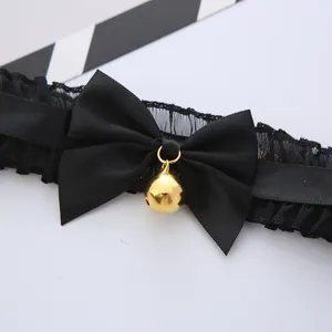 Black lace choker necklace with satin bow and gold bell, cute cat style fashion accessory for women.