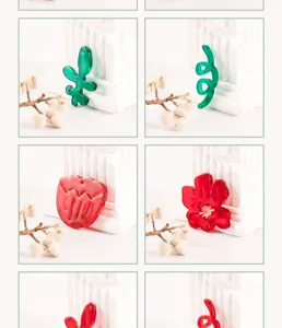 Close-up detail view of colorful tulip flower and leaf acrylic clog charms for DIY jewelry.