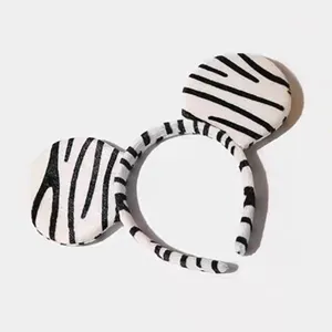 Cute plush animal ear headband with black and white stripes for party and cosplay events.