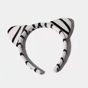 Cute plush tiger ears headband with black and white stripes, perfect for parties and events.