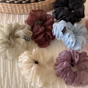 Organza scrunchie detail showcasing sheer fabric texture, elegant colors for hair styling.