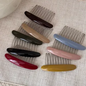 Colorful acetate hair comb detailed view, elegant metal teeth and glossy oval design hair accessory.