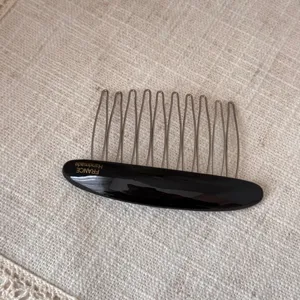Elegant black acetate hair comb with metal teeth, perfect for women styling bangs and chic buns.