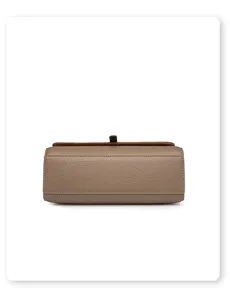 Close-up detail of leather handbag bottom gusset with soft taupe texture and contrast trim.