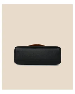 Detailed view of the black soft leather women handbag bottom showing fine texture and durable stitching.