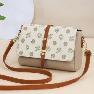 Womens vintage soft leather crossbody bag with retro print flap and adjustable strap.