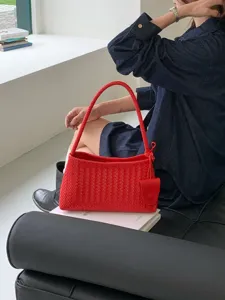 Chic red woven leather shoulder bag, intrecciato baguette handbag for daily commute and fashion wear.