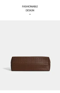 Detailed view of the brown woven tote bag, showing the exquisite textured bottom design.