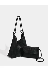 Detailed view of the black woven tote bag featuring soft texture and matching pouch design.