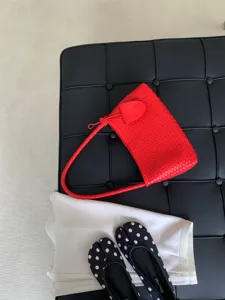 Red woven leather shoulder bag, trendy French style women's underarm baguette handbag.