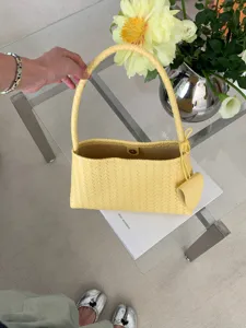 Yellow woven leather shoulder bag chic braided underarm handbag for women daily commute style.