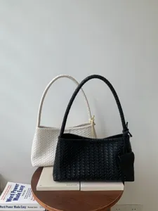 French chic woven shoulder bag, elegant commuting handbag, fashionable hobo baguette bag.